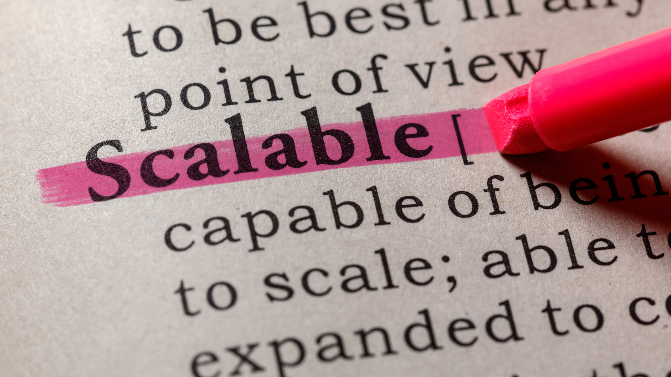 Highlighter pen highlighting word "Scalable" on a document.