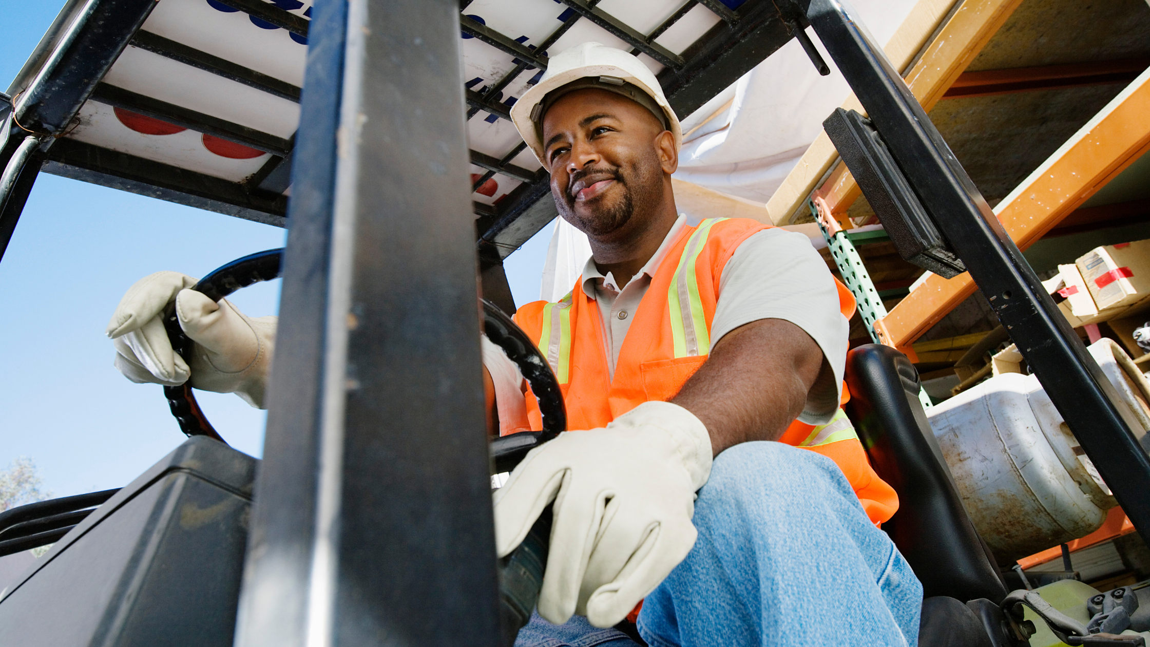 Man outdoors operating a fork lift.